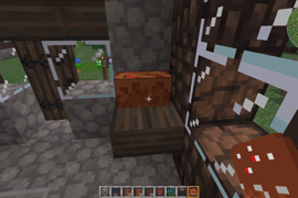 A half-eaten chocolate cake sits on a table in a house